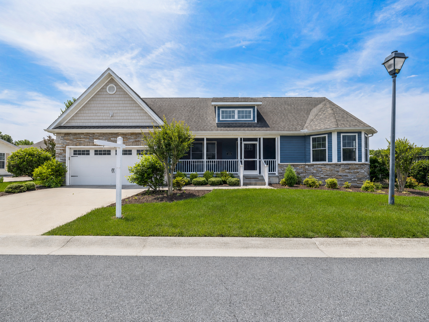 Exterior of 134 Salt Creek Drive, a one-level ranch home with an attached two-car garage on a corner lot in Dover, Delaware
