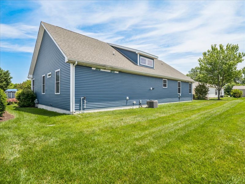 Side exterior of the home with open lawn at 134 Salt Creek Drive, Dover, Delaware