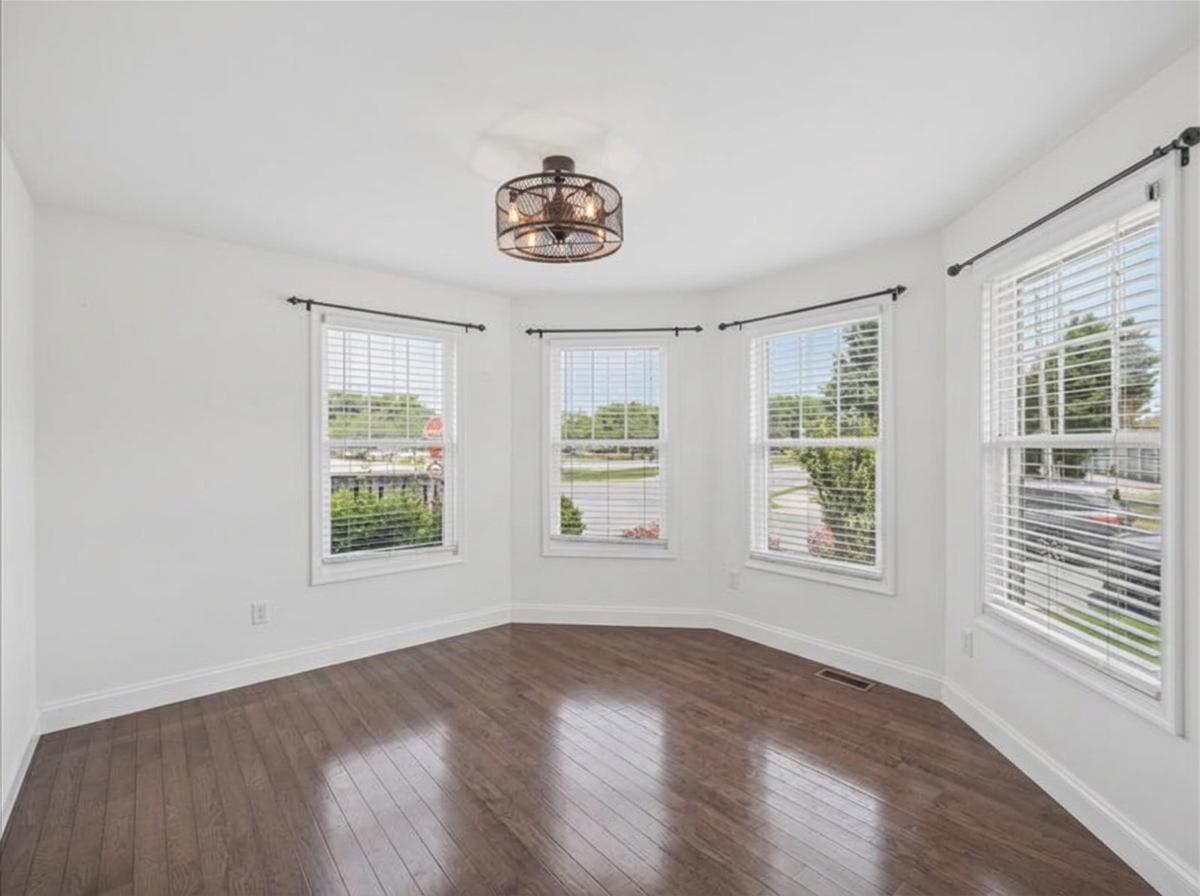 Bright dining area with bay windows and dark hardwood floors at 134 Salt Creek Drive, Dover, Delaware